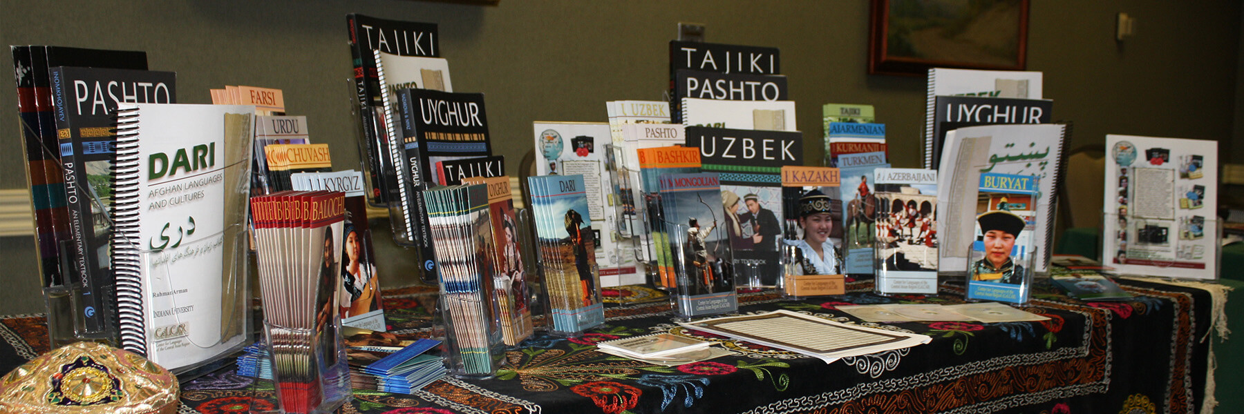 A table with various language textbooks and flyers.