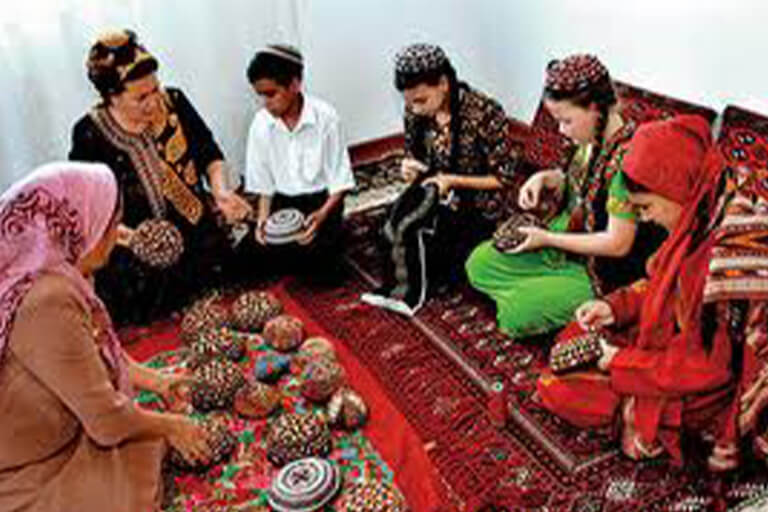 A group of people sitting on rugs.