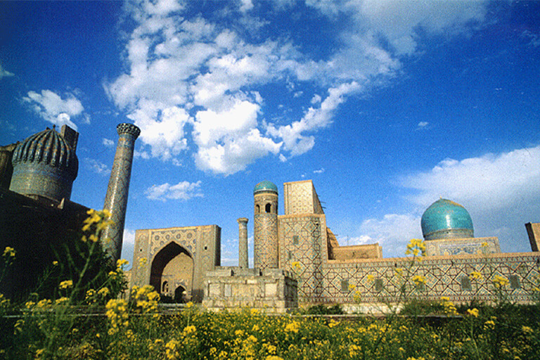 Some buildings in Central Asia are under a bright blue sky.